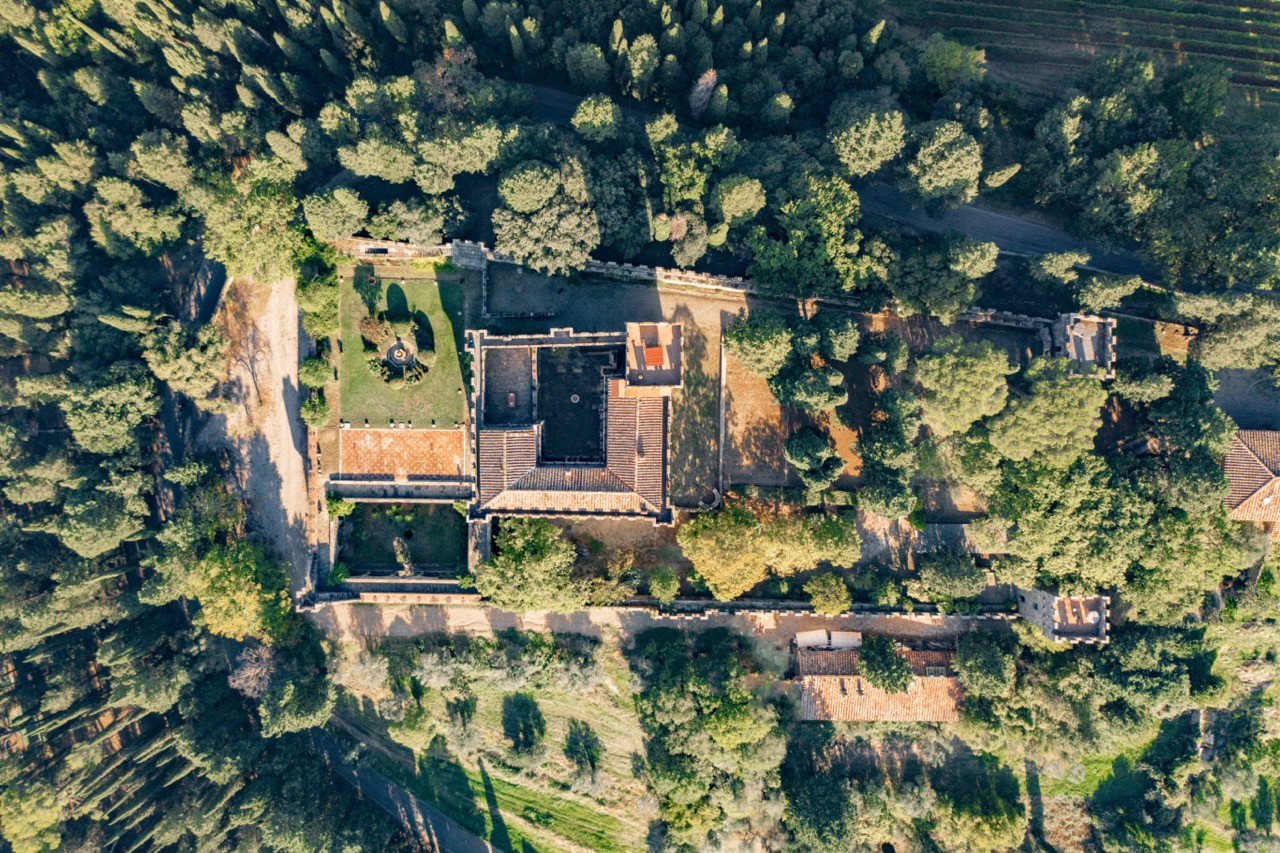 Bird’s eye view of Castello di Vincigliata showing the castle layout and surrounding estate buildings, demonstrating the scale and organisation of this historic European castle available for events and accommodation development