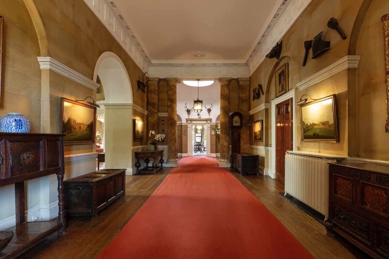 The Reception Hall at Ripley Castle featuring period furnishings and hunting trophies, part of the Georgian era reconstruction completed by 1786 at this historic European castle with three distinct architectural periods