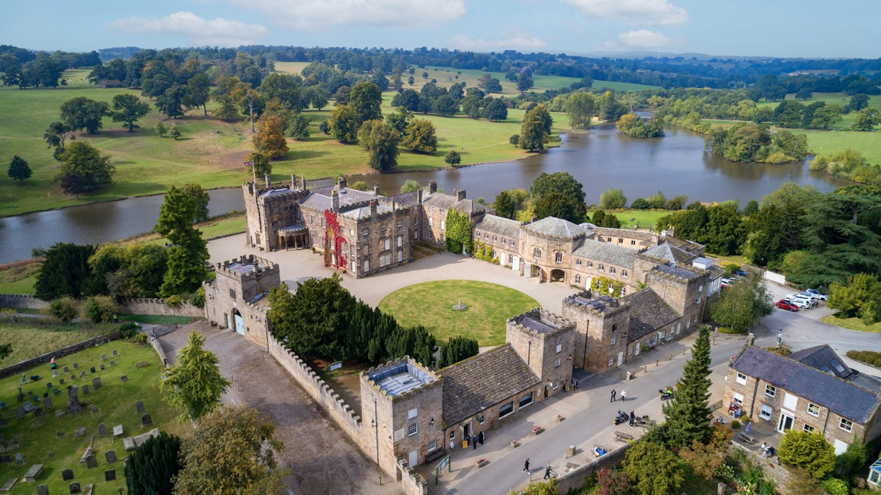 Aerial view of Ripley Castle complex showing the main castle, estate offices, and East Wing buildings used for the successful wedding business, demonstrating the scale of this historic European castle in Harrogate
