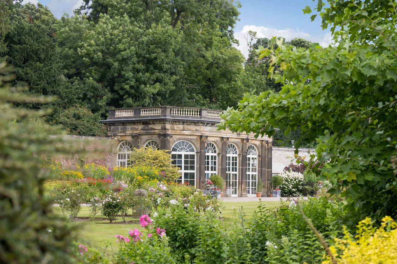 The Orangery within Ripley Castle’s four-acre walled gardens, containing palm trees and tropical plant collection as part of the stunning landscaped grounds surrounding this historic European castle