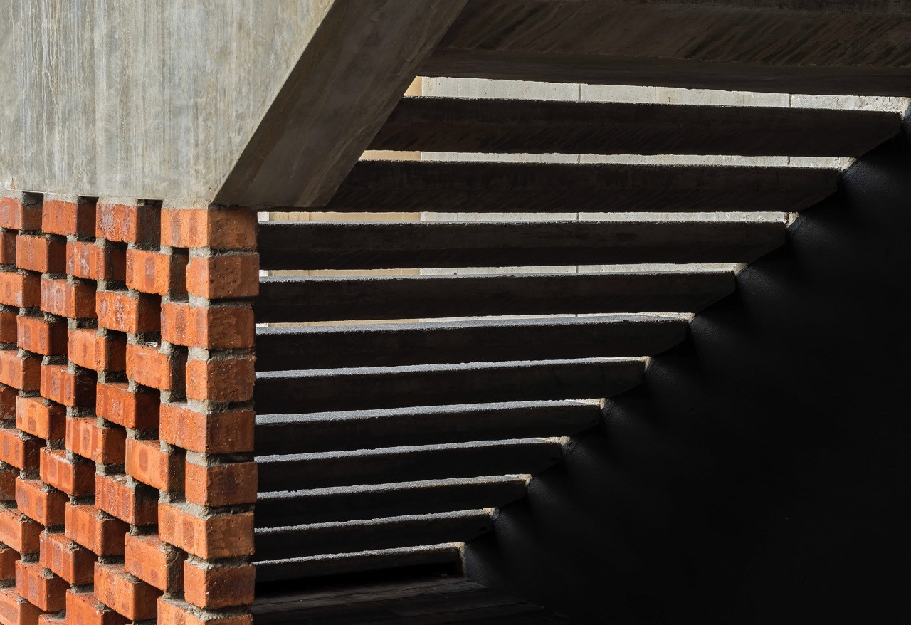 Detail of clay brick construction meeting concrete structure, showing material junction and construction precision