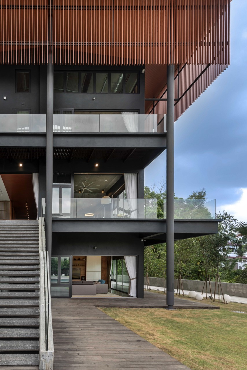 Building transparency across hillside with extensive glazing creating interior-landscape connections