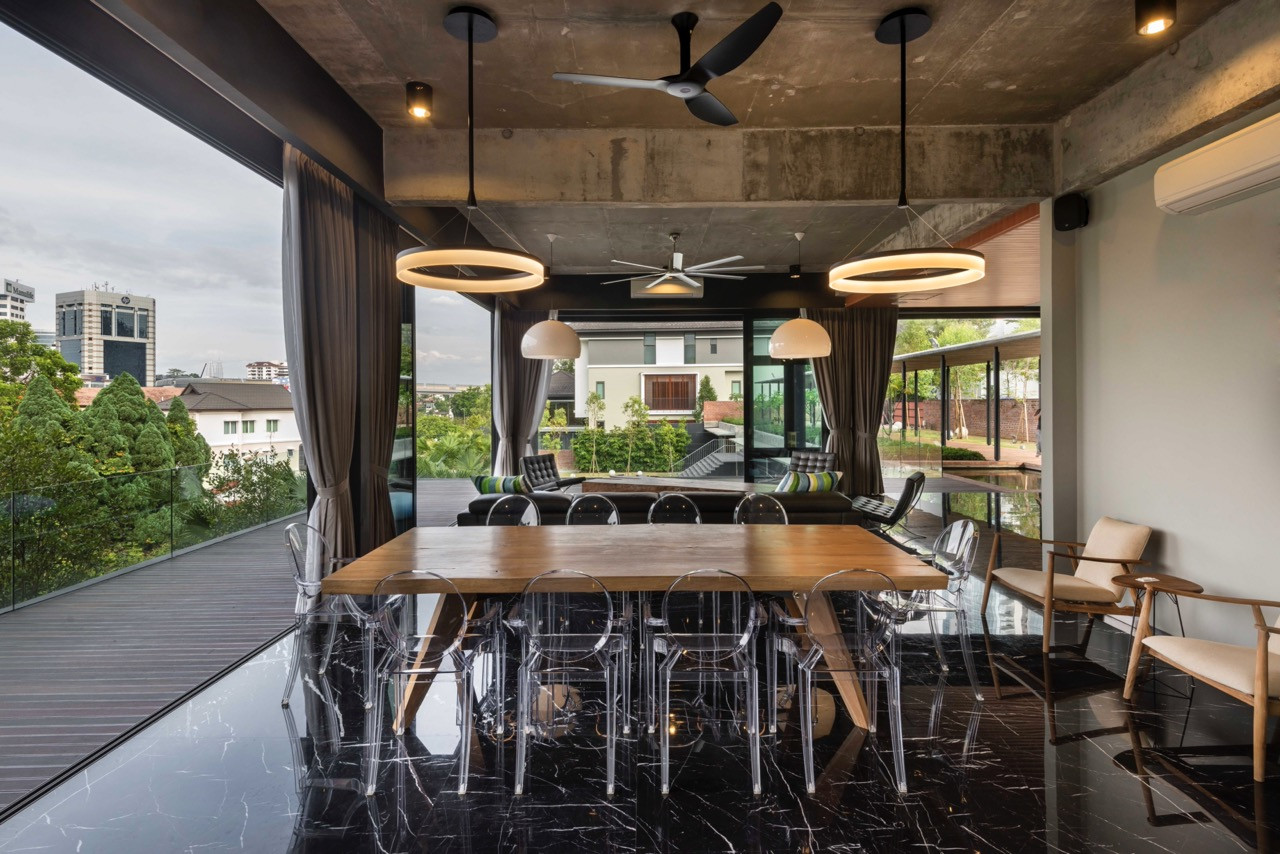 Family dining space showing the connection between kitchen, dining, and outdoor areas with contemporary furnishing