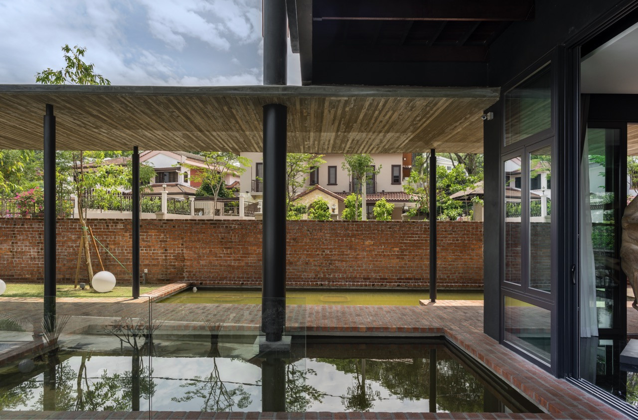 Views beneath a protective timber canopy showing the tropical modern house within an established residential context