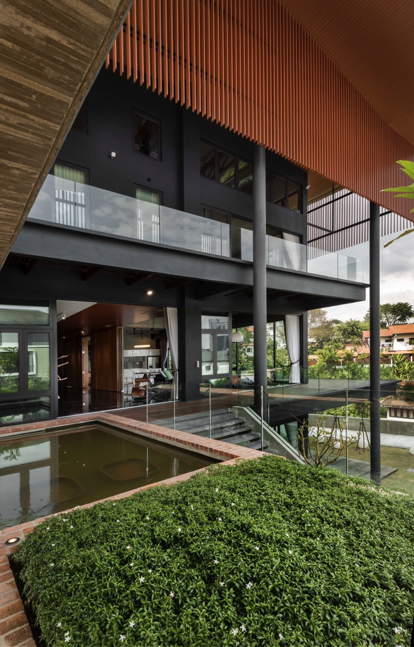 Multi-level view showing concrete structure, timber screens, and integration with landscape and reflecting pools
