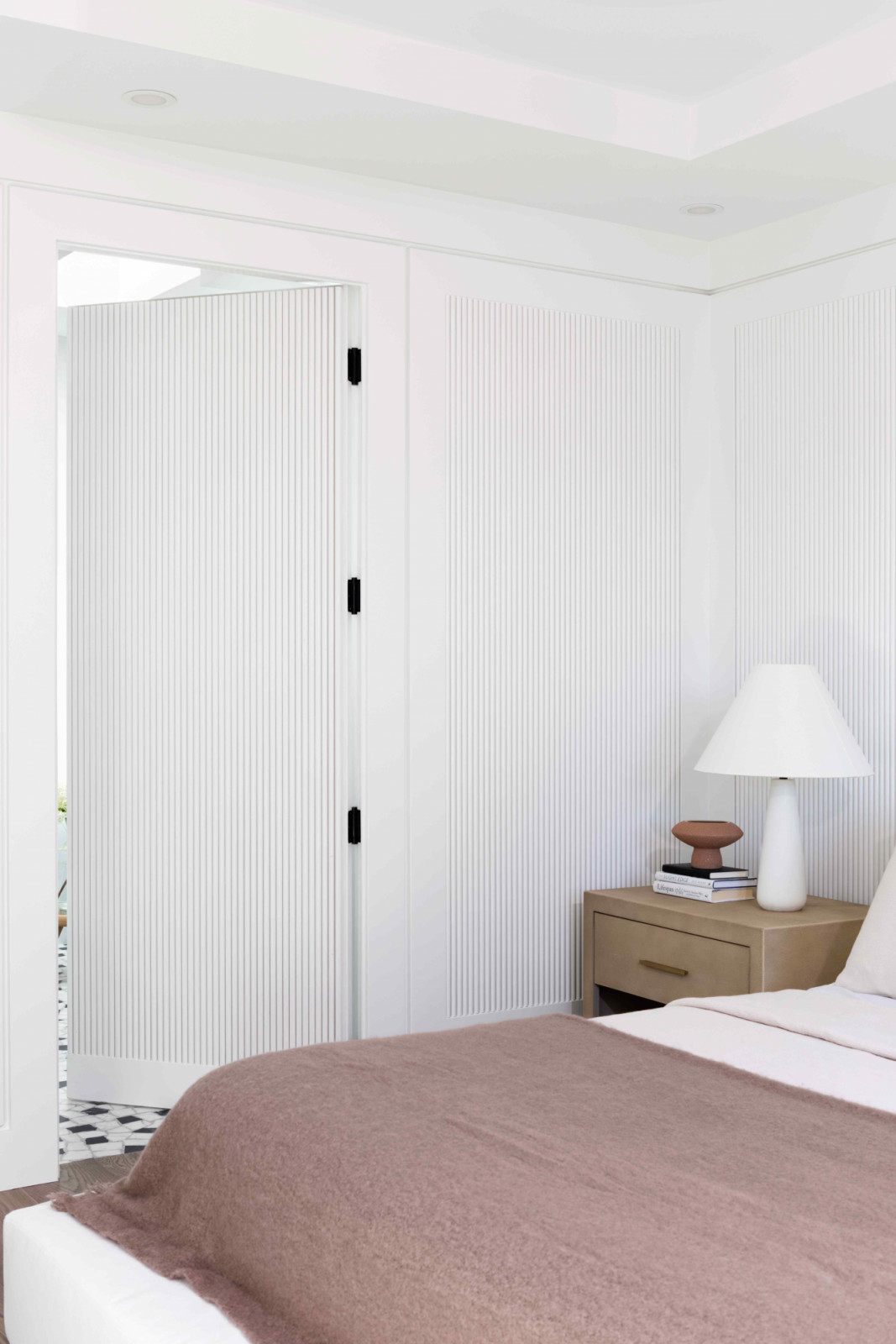 White fluted panels achieve a refined aesthetic in the eldest daughter’s bedroom