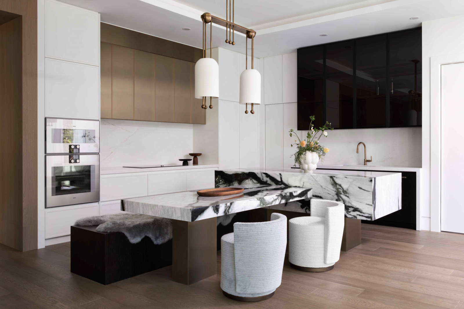 A bold Panda White marble kitchen island anchors the space