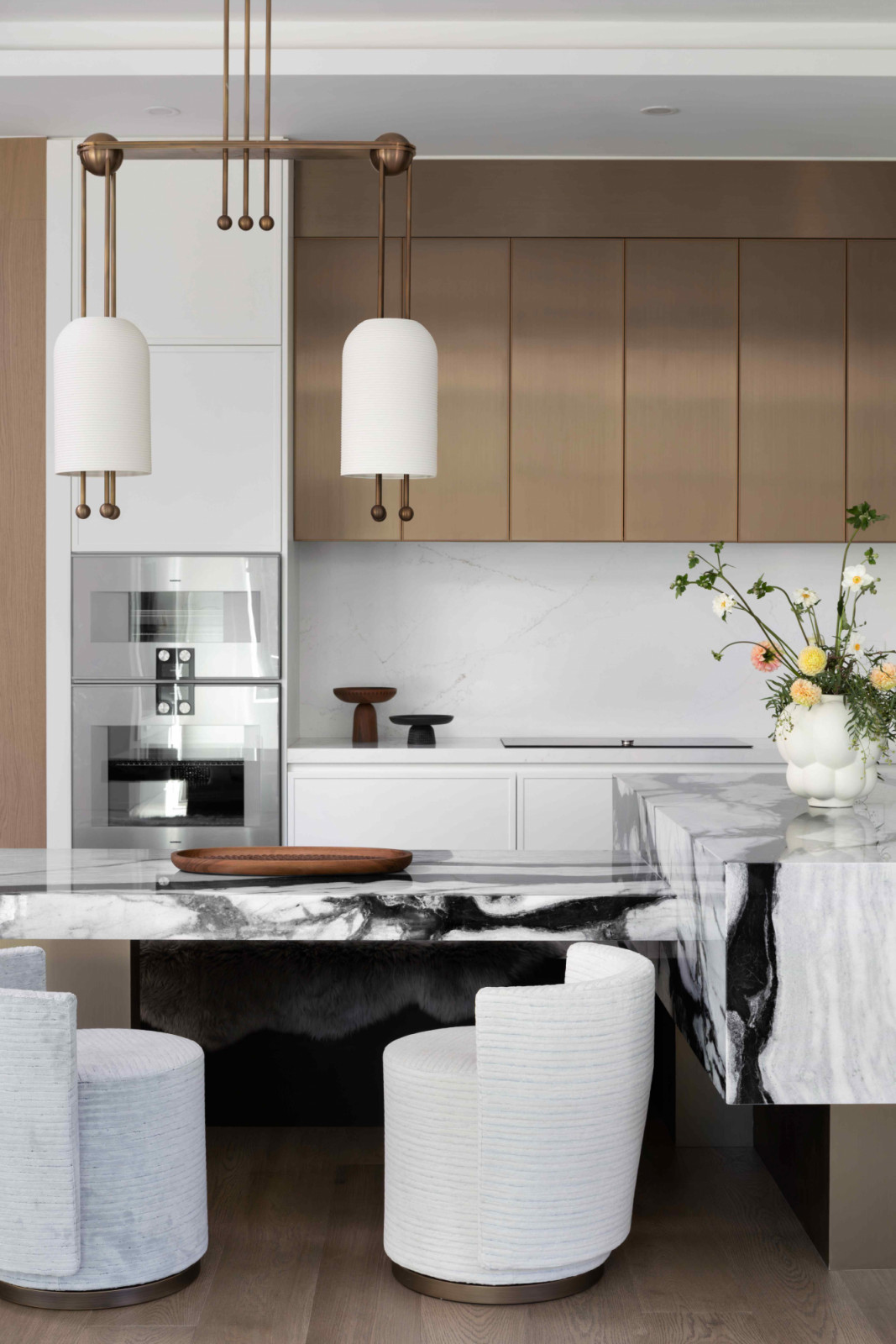 The distinct, custom shape appeals to the homeowners’ preference for dining-height seating
