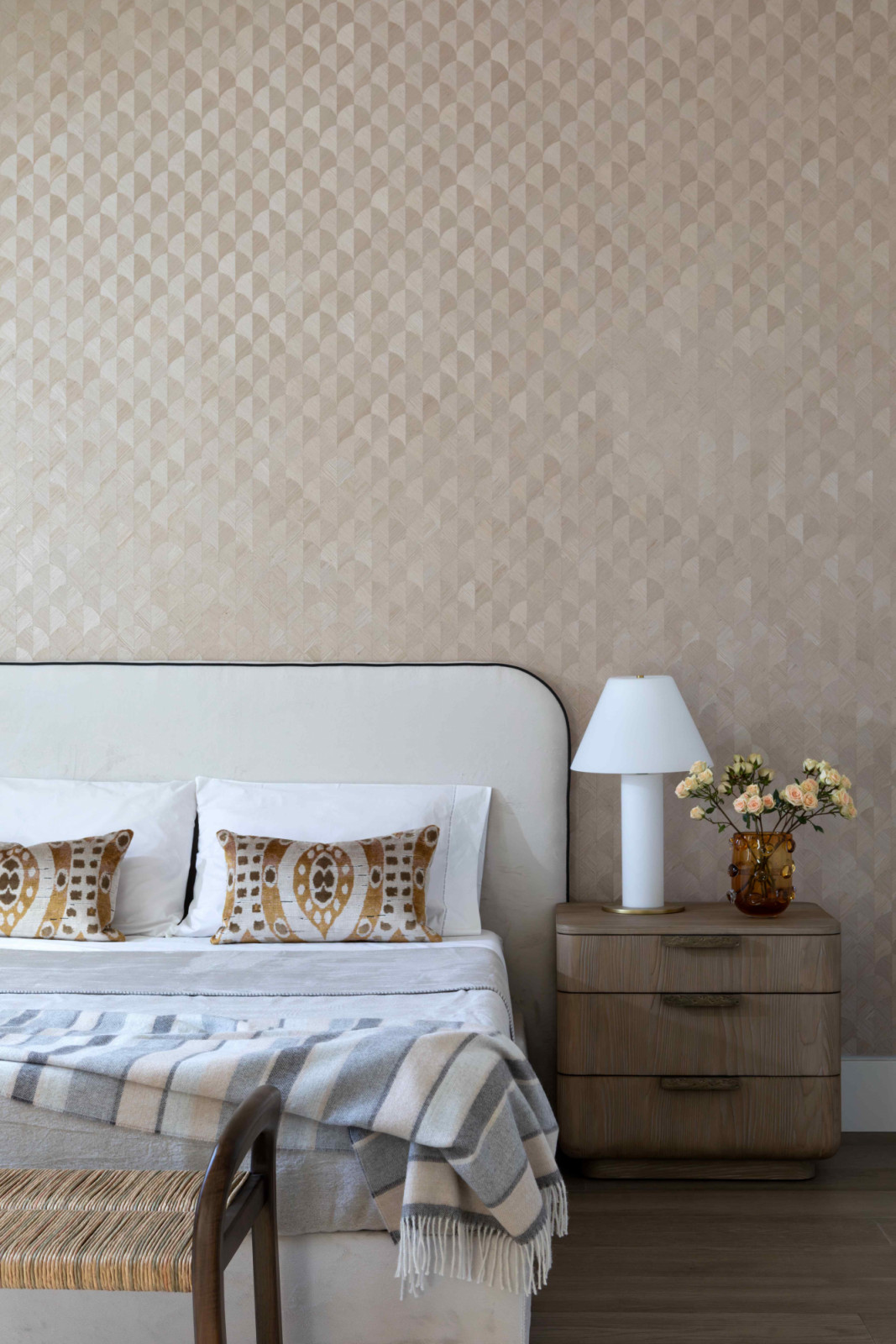 Soft, geometric wall covering sets a textured, neutral backdrop in the main ensuite bedroom