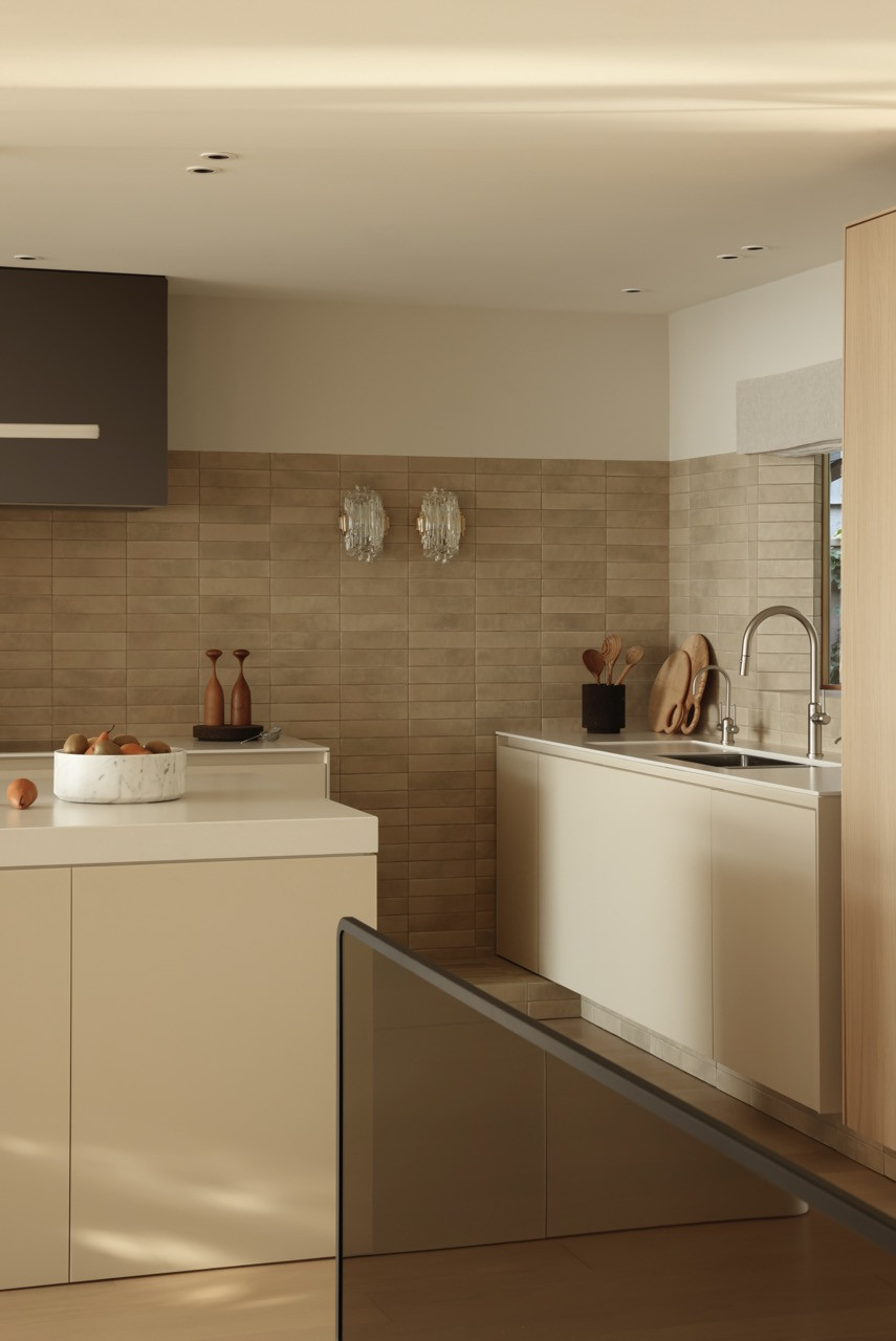 The kitchen’s Spanish porcelain tile backsplash adds texture reminiscent of reclaimed bricks, whilst vintage crystal lighting creates layered illumination throughout the cooking area