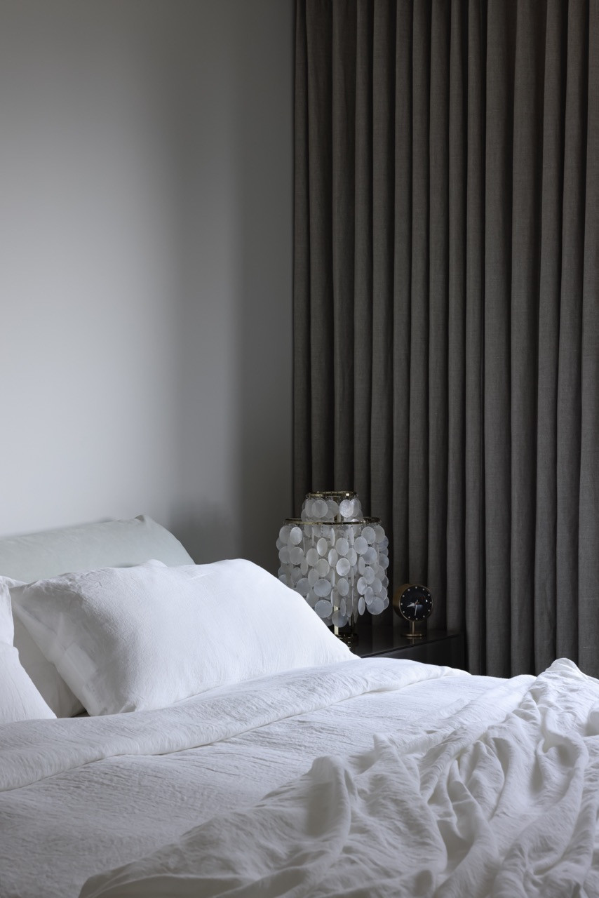 The primary bedroom features linen bedding by Sömn, creating a serene retreat where the homeowner’s two university-aged children join her during summer