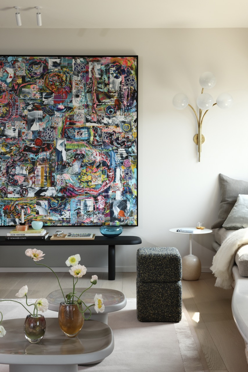 The family room features a collage by Michiel Folkers and demonstrates how the designers used the homeowner’s art collection as inspiration to curate furnishings with bold colours and sculptural forms