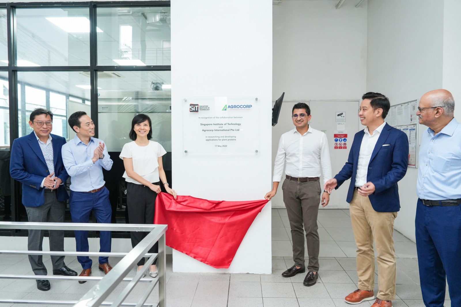 Vishal Vijay (fourth from left), CEO of Agrocorp, with representatives from the Singapore Institute of Technology (SIT) at the unveiling of a plaque commemorating their collaboration in research and development of plant protein applications, 17 May 2022.