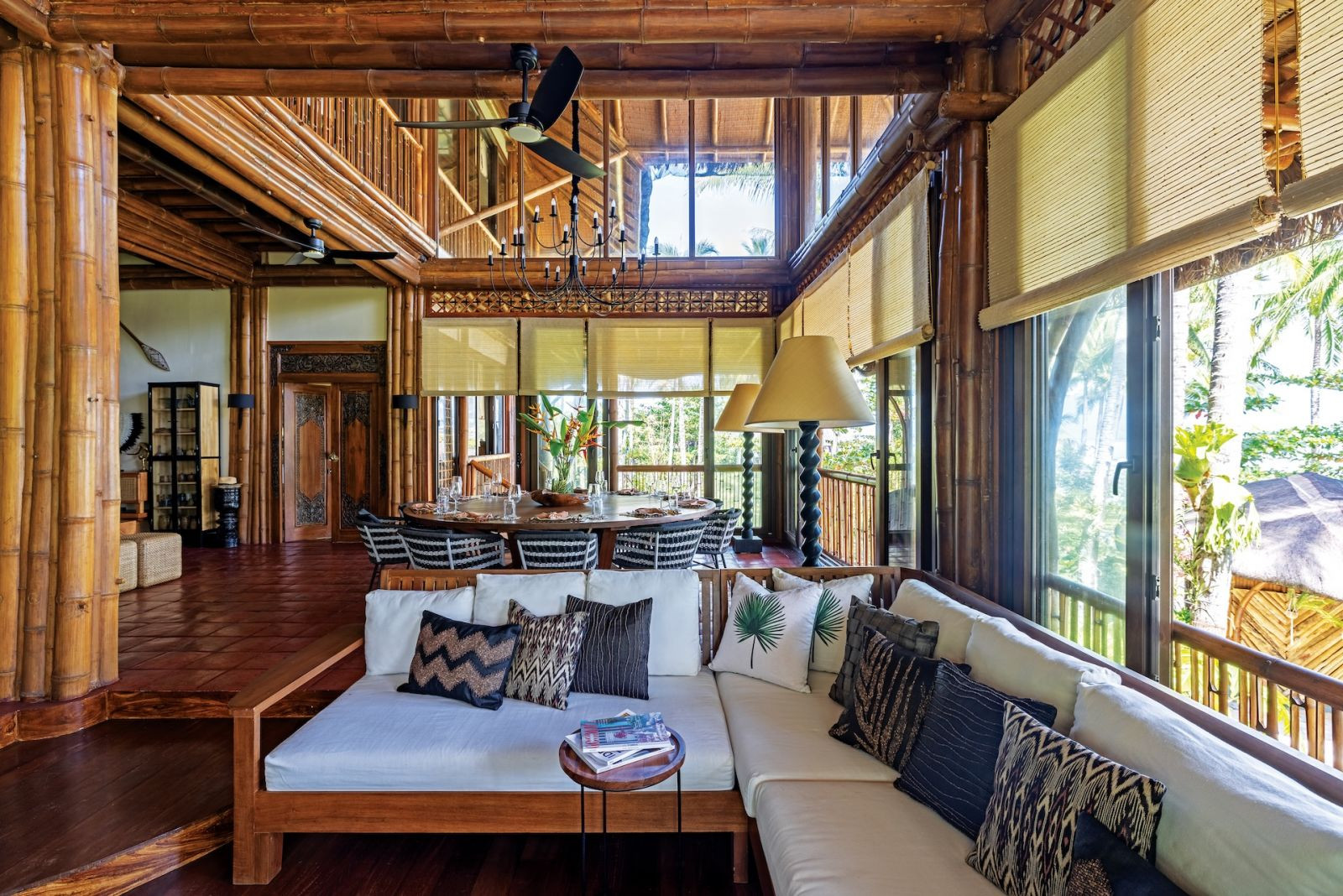 The living room of Aman Sinaya on Mati Island, Mindanao, with throw pillows by Maricris Floirendo-Brias for Tadeco; handcarved solid wood front door flanked by two staircases (Photo: Scott A Woodward)
