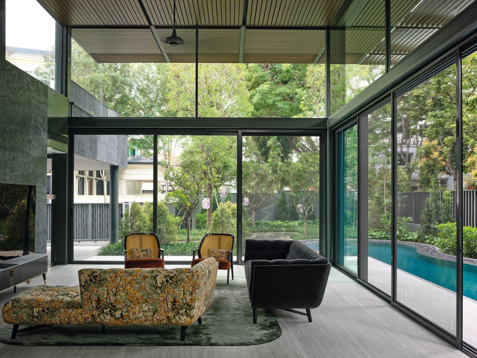 The living room features double-volume glass panes that invite the outdoors into the home, as well as furnishings from Roche Bobois, including the Profile sofa, Weg armchair and Eden Rock TV unit (Photo: Derek Swalwell)