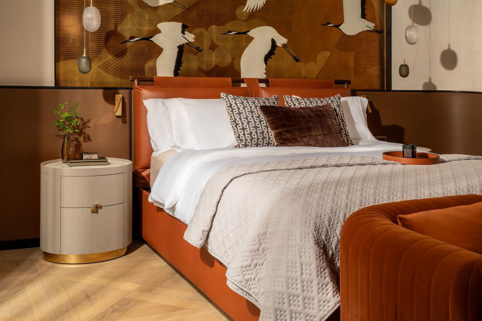 A bedroom clad in rich, warm jewel tones in a Hong Kong multigenerational home designed by Liquid Interiors