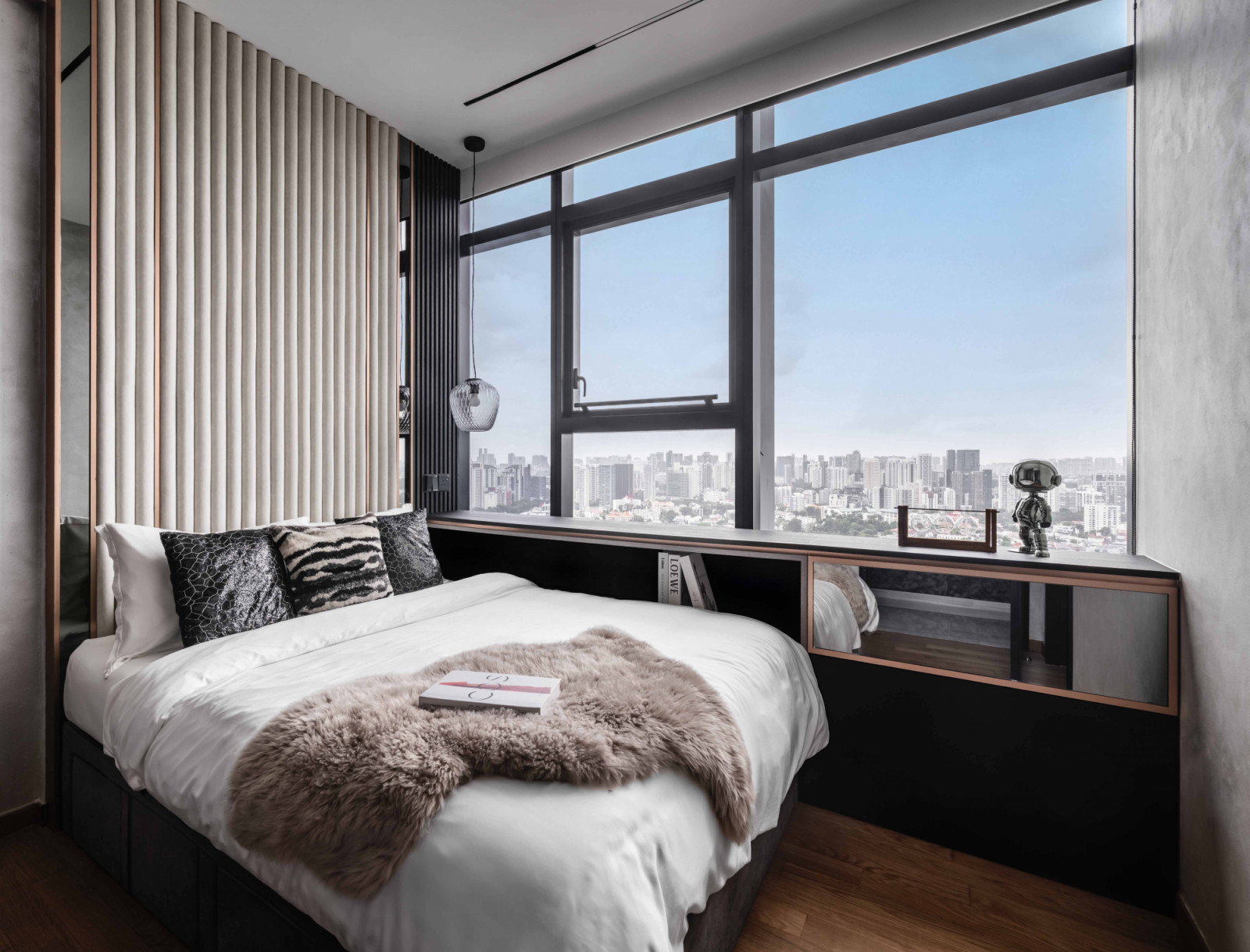 Shades of greige and a fluted bedhead soften the masculine colour and material palette in this bedroom
