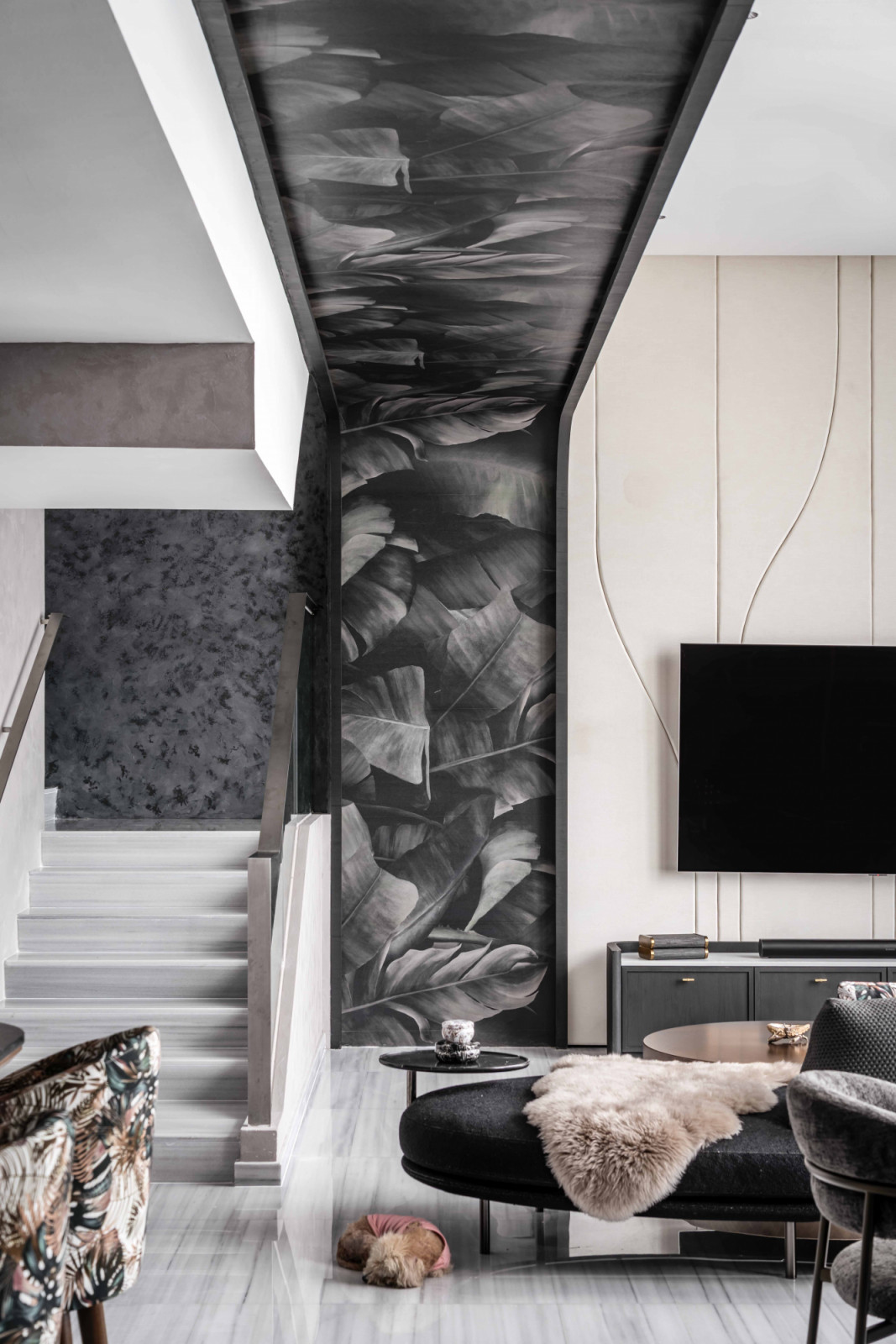 Greyscale botanical-patterned wallpaper elegantly defines the architectural threshold of the penthouse’s living area