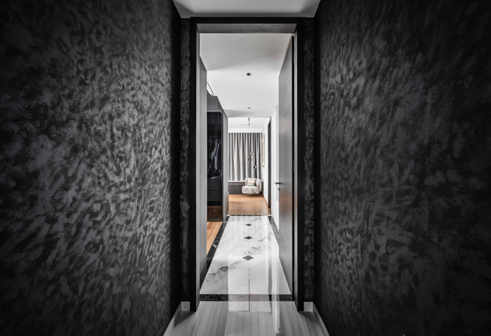 A damask-effect charcoal wallcovering adds drama to the corridor