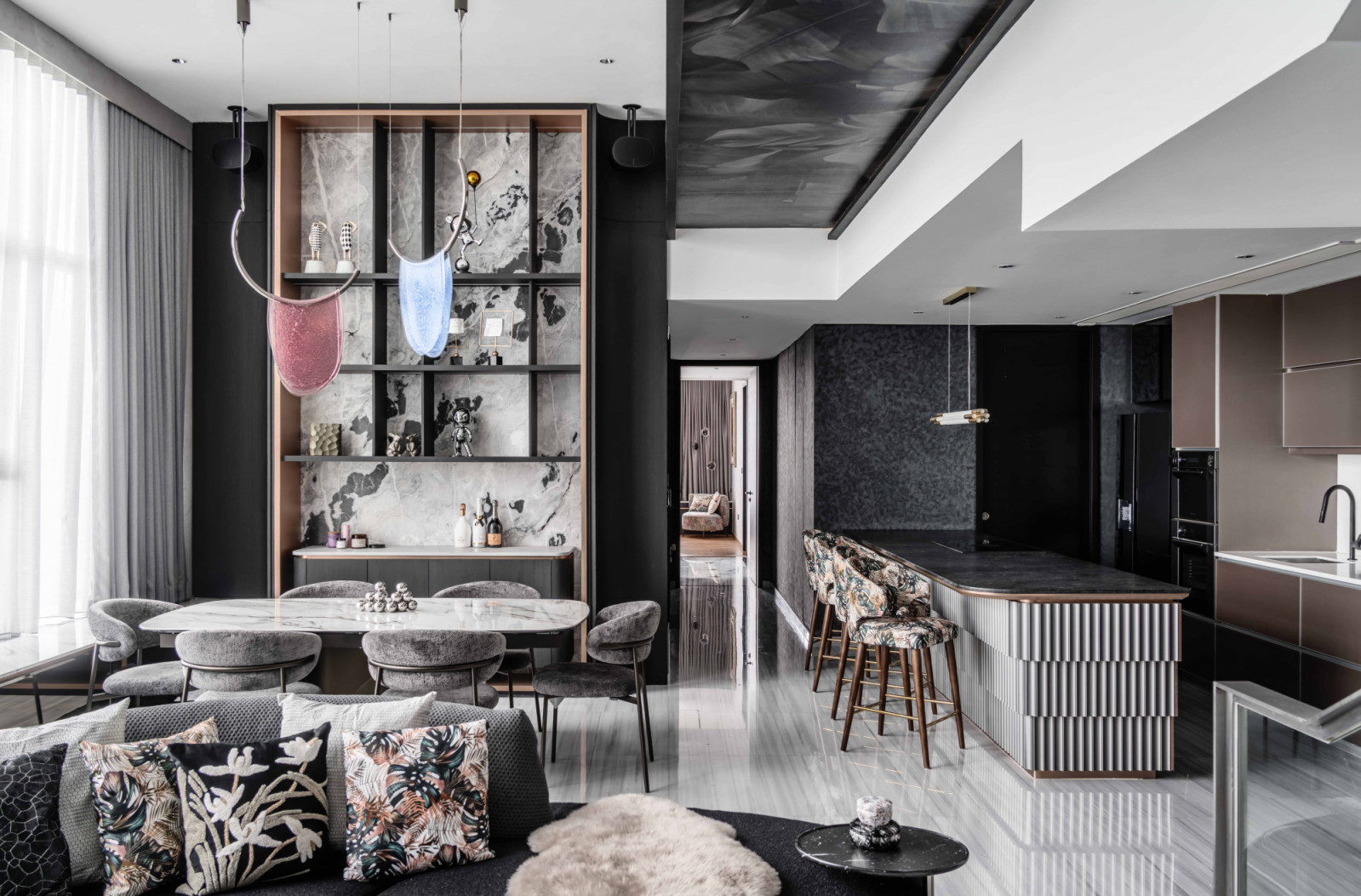 Floral upholstery, textured surfaces and warm-toned interior elements lend a stately, feminine touch to the penthouse’s living, dining and kitchen areas