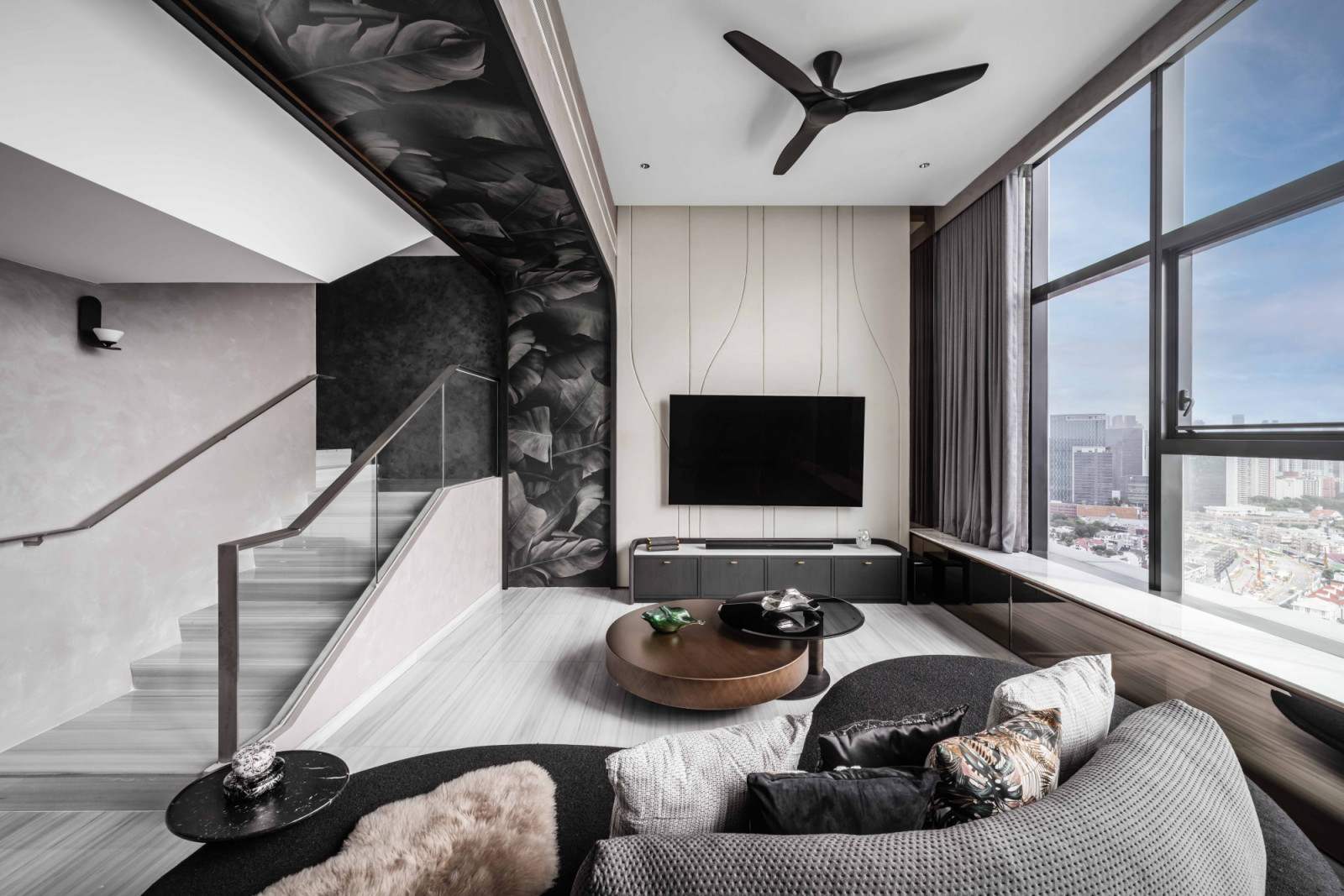 The penthouse’s handsome sitting area features plush low-slung furniture and a spectacular view of Singapore’s skyline