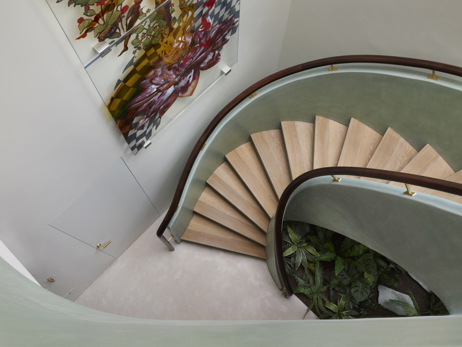 An aerial view of the jade green staircase and commissioned artwork by Shazia Sikander in a Kensington, London home designed by Boundary Space