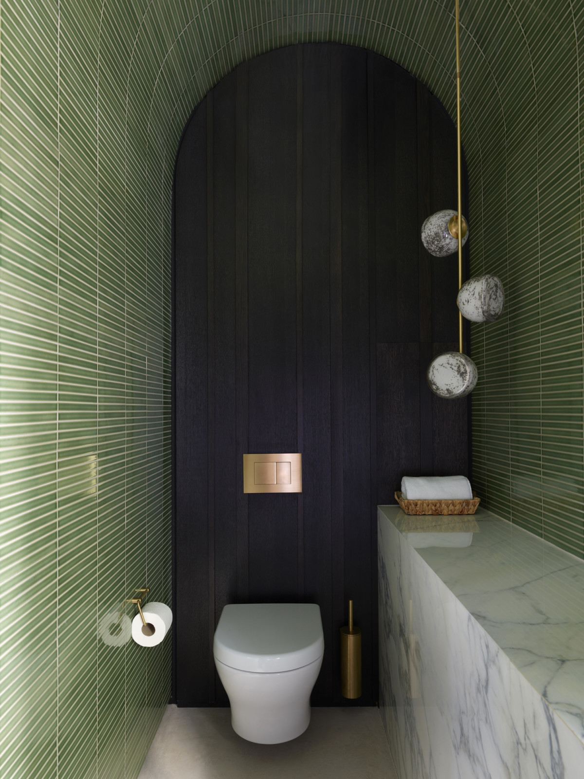 Green tiles in the bathroom of a Kensington, London home designed by Boundary Space