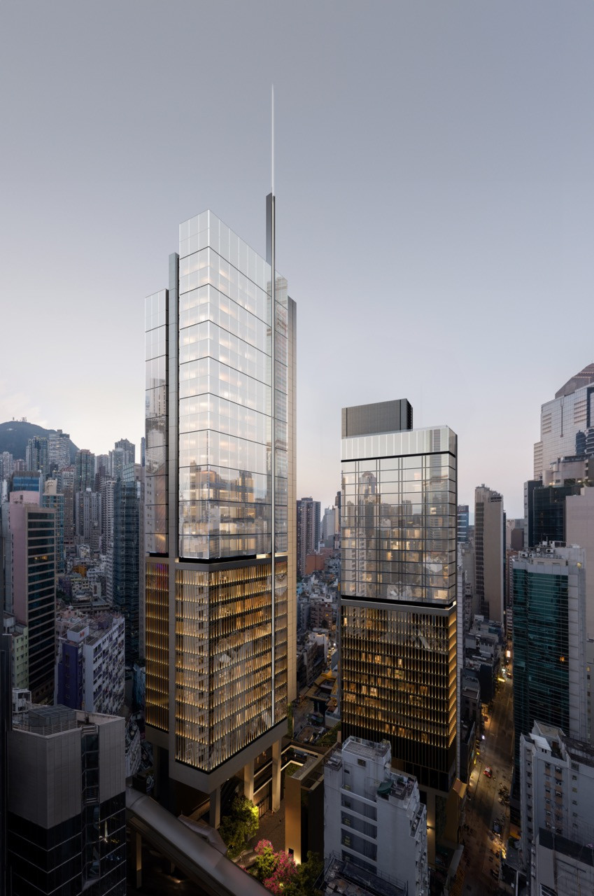 The mixed-use towers of Central Crossing rise above Hong Kong’s dense urban fabric. Foster + Partners' design features articulated facades with tighter grain at lower levels, transitioning to expansive glass at upper floors for panoramic city views.