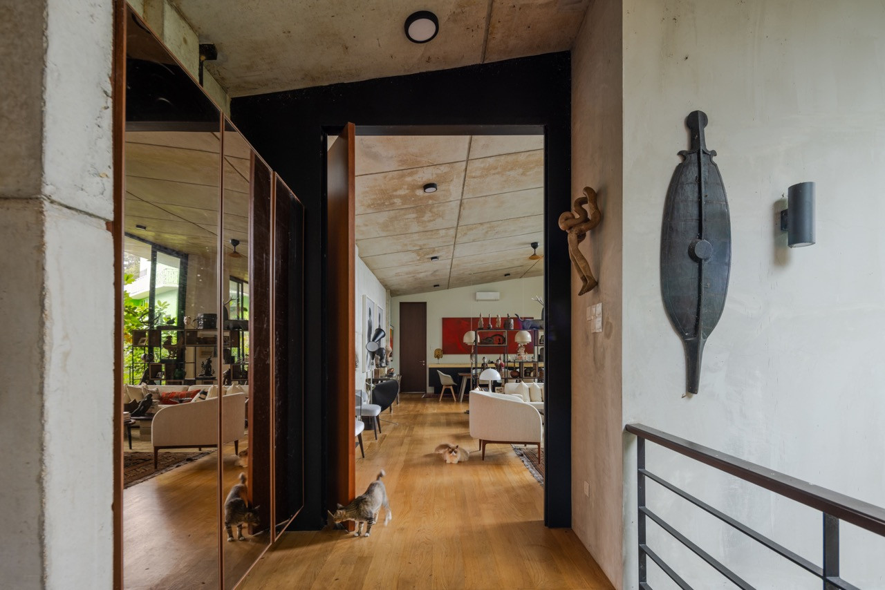 Ancient weaponry and traditional artefacts line the timber-clad passageway