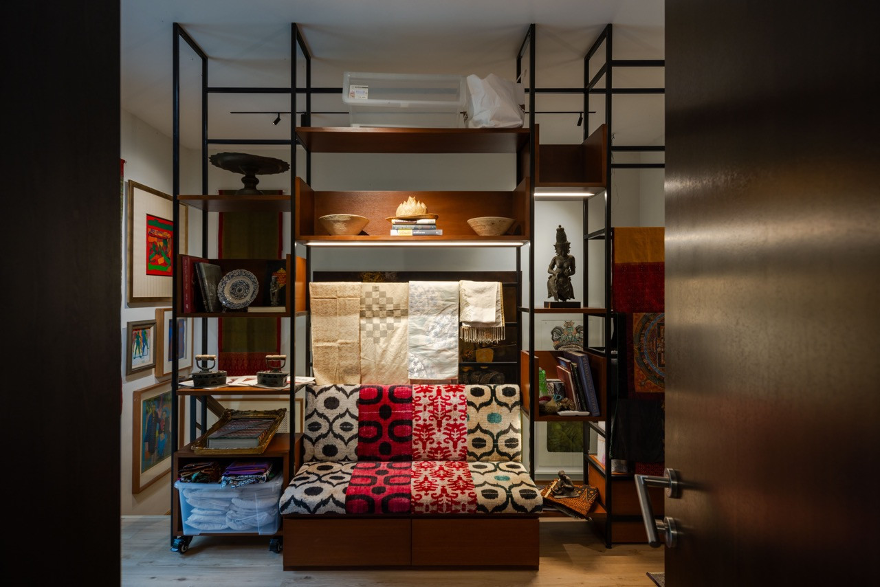 Custom steel shelving systems display the clients’ curated archive of artefacts