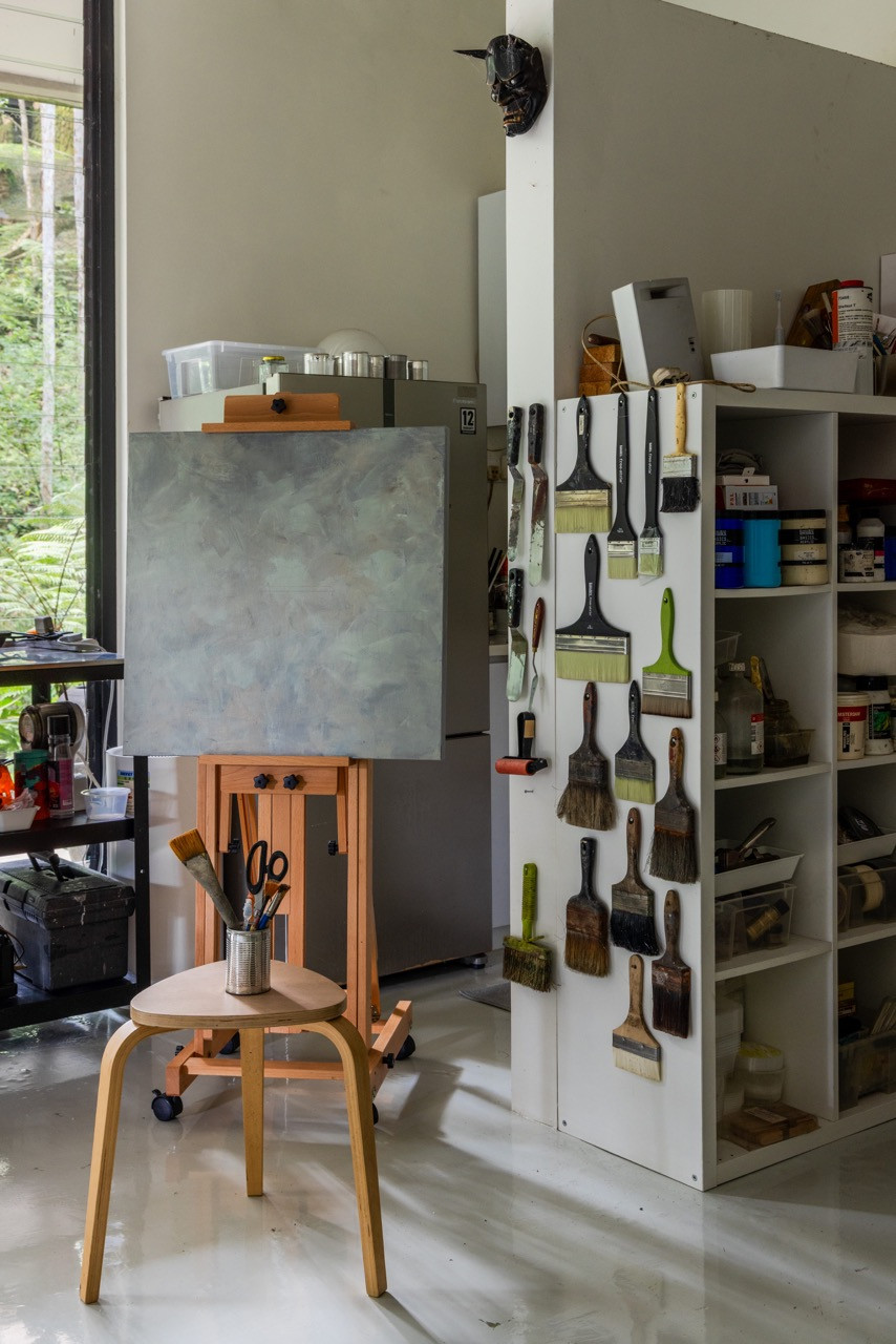 The clients’ creative workspace sees paintbrushes and art supplies organised alongside artefacts