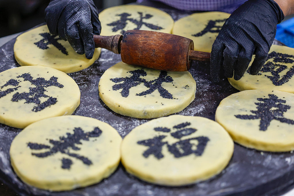 HUANGSHAN, CHINA - SEPTEMBER 18: A pastry worker makes Huizhou-style mooncakes in preparation for the upcoming Mid-Autumn Festival on September 18, 2025 in Huangshan City, Anhui Province of China. (Photo by Shi Yalei/VCG via Getty Images)