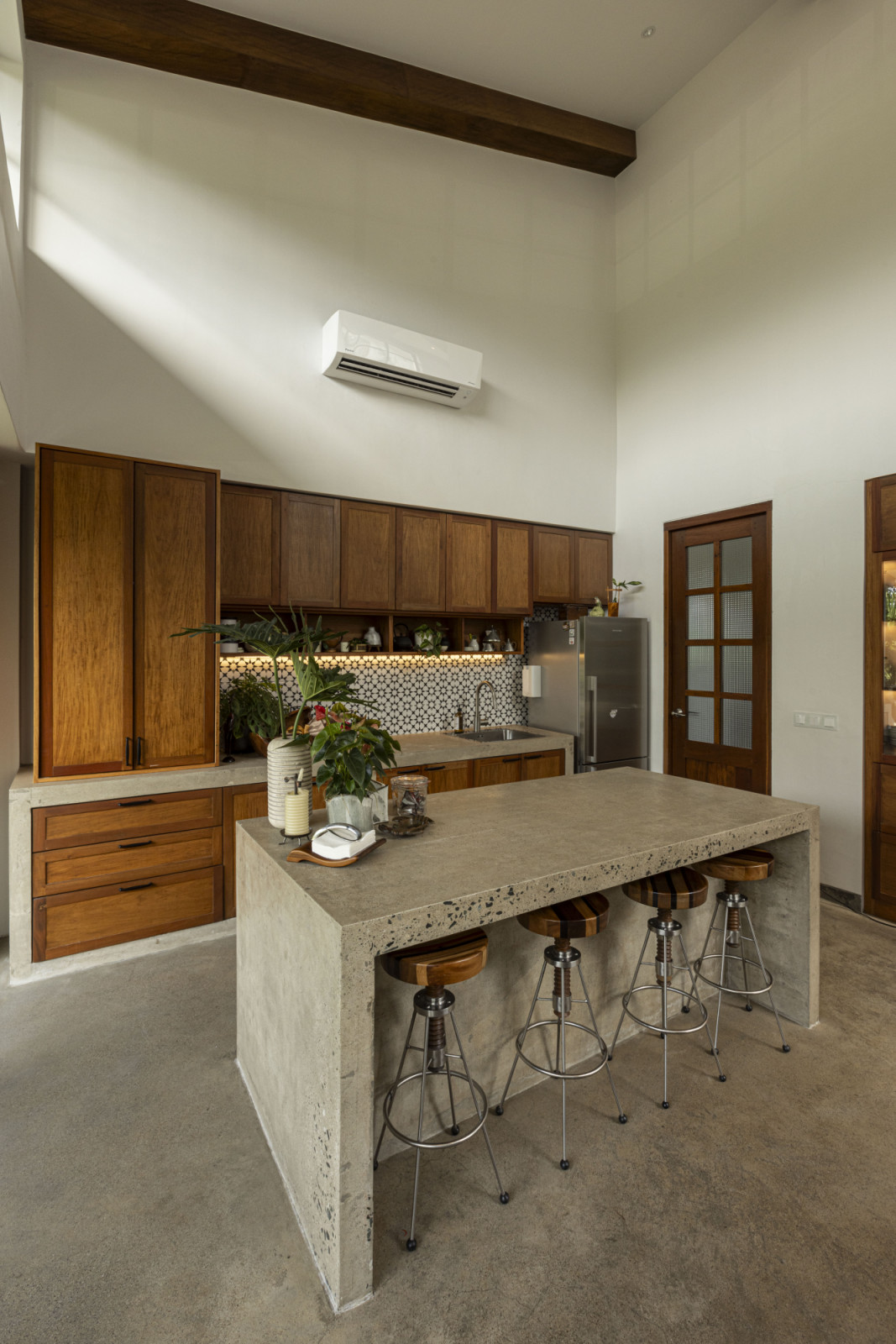 The kitchen of a verdant Laguna, Philippines family home designed by architect Miko Delos Reyes