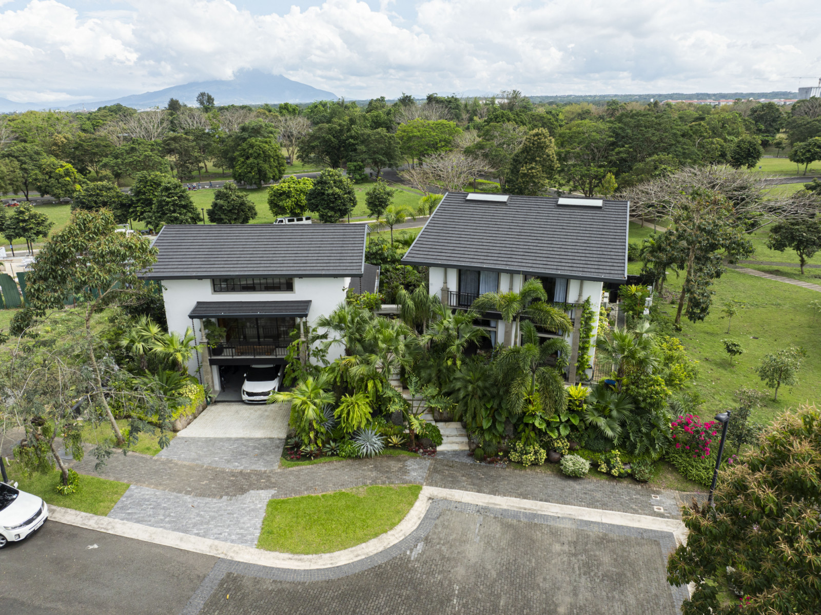 The exterior of a verdant Laguna, Philippines family home designed by architect Miko Delos Reyes