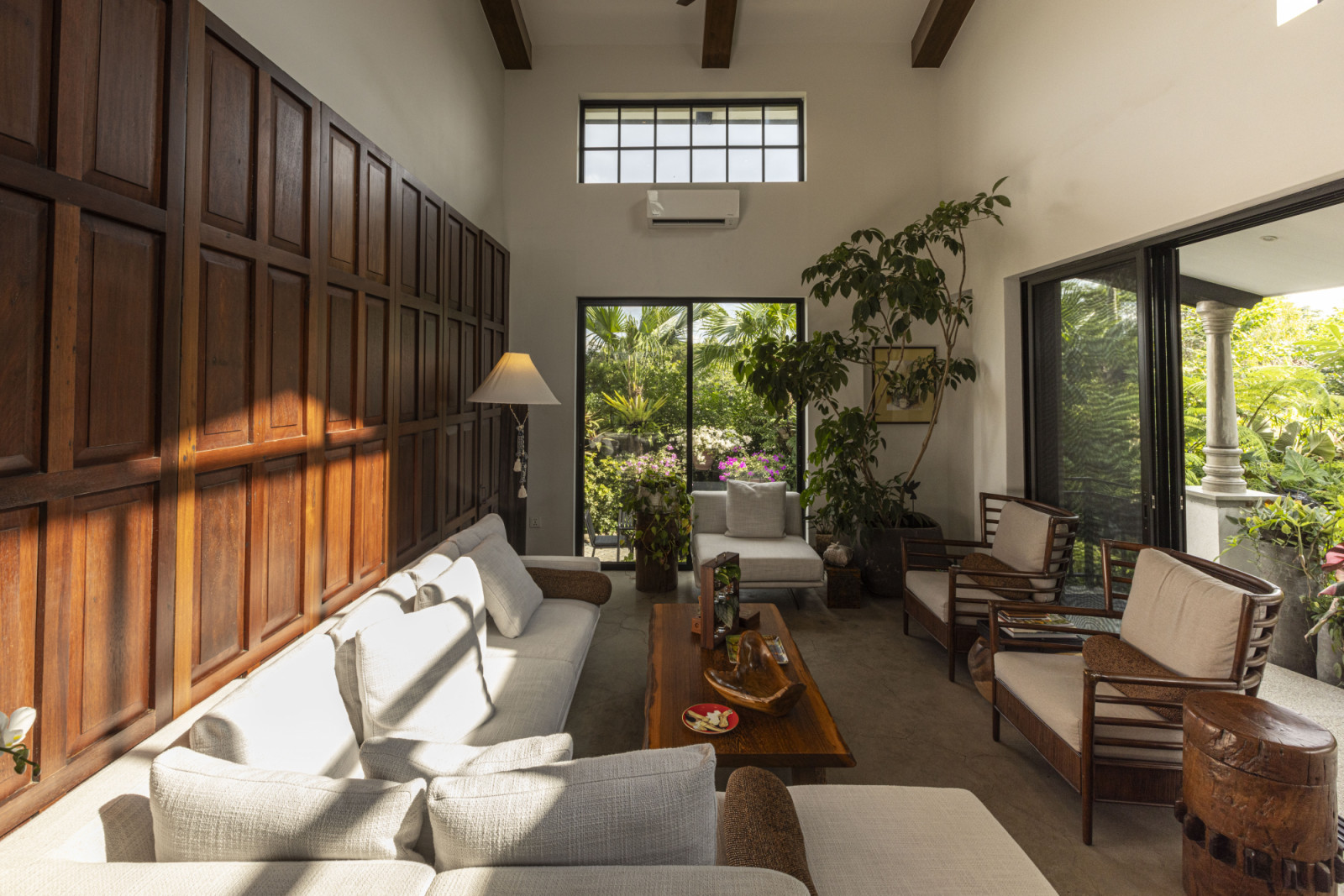 The living room of a verdant Laguna, Philippines family home designed by architect Miko Delos Reyes