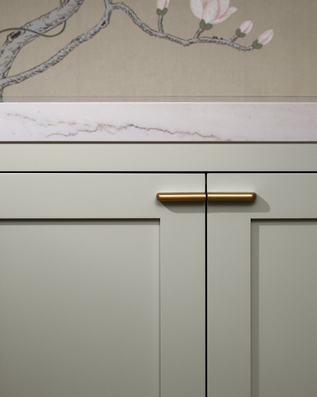 Detail of kitchen cabinetry featuring custom brass hardware by female-owned business Hoffman Hardware, emphasising the designers’ commitment to supporting smaller makers and artisans