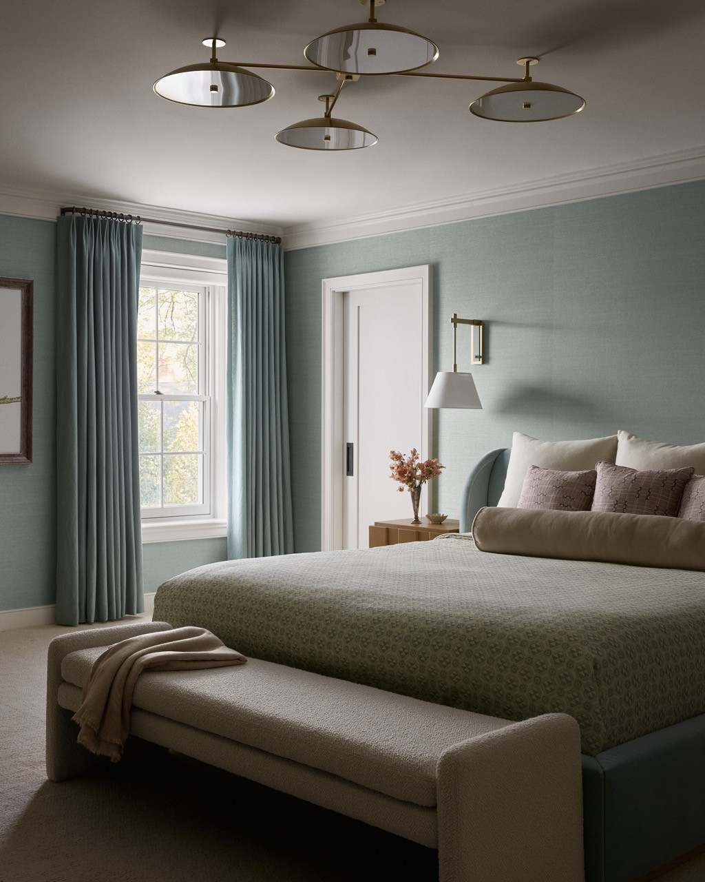 The duck egg blue bedroom demonstrates the designers' layered approach to colourful interiors, with multiple shades and textures creating depth without pattern overload