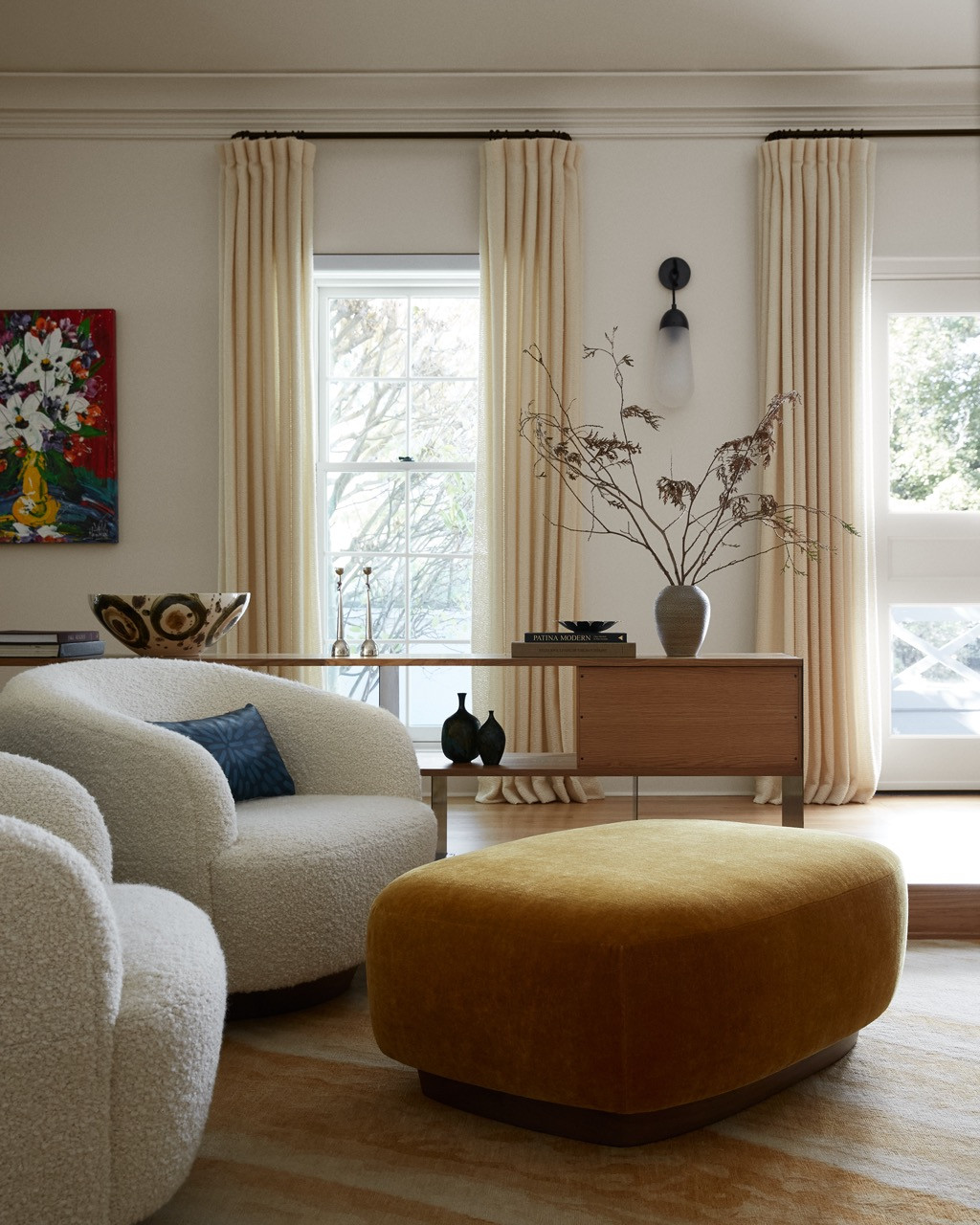 The living room’s neutral palette allows the couple’s vibrant art collection to take centre stage, with textured upholstery in natural fibres adding tactile interest