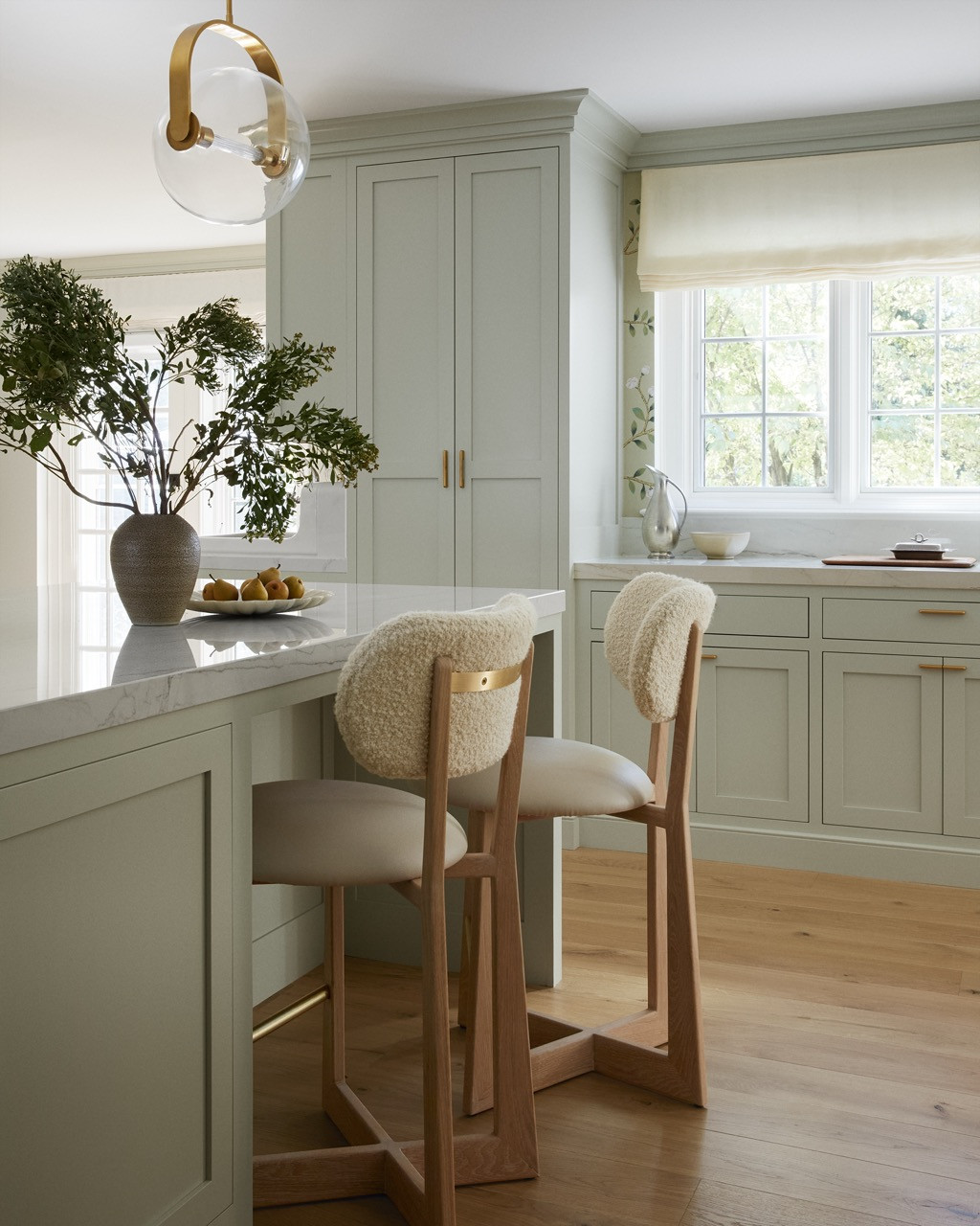 Detail of the kitchen’s breakfast area showing AP counter stools by Thomas Hayes paired with the island