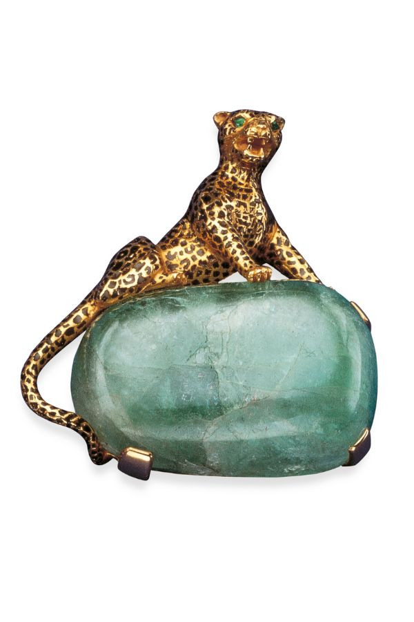 The iconic Cartier brooch with the panther sitting atop an emerald stone