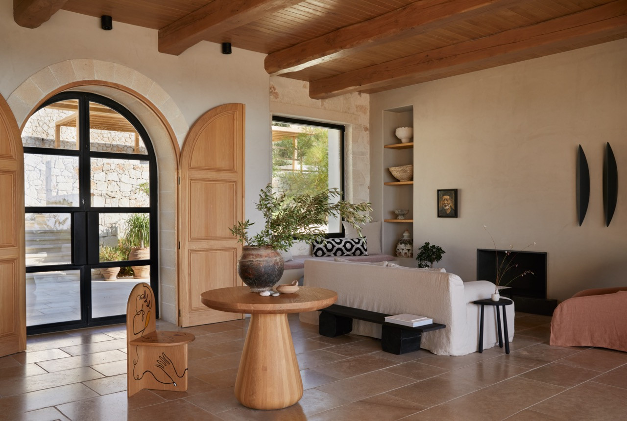 The main bedroom's custom furniture and arched doorways showcase the home's blend of traditional Cretan elements with contemporary design