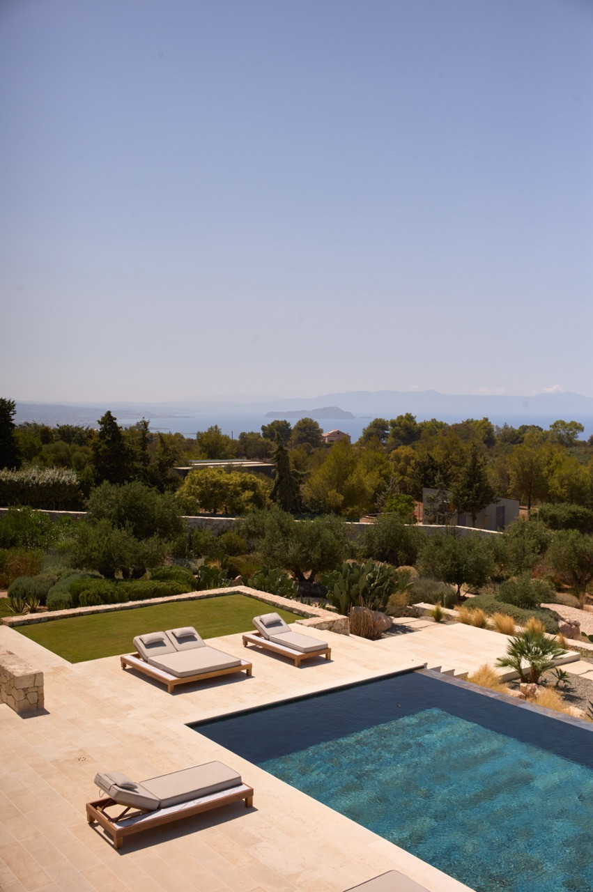 The swimming pool overlooks the Mediterranean garden and olive groves with views towards Souda Bay