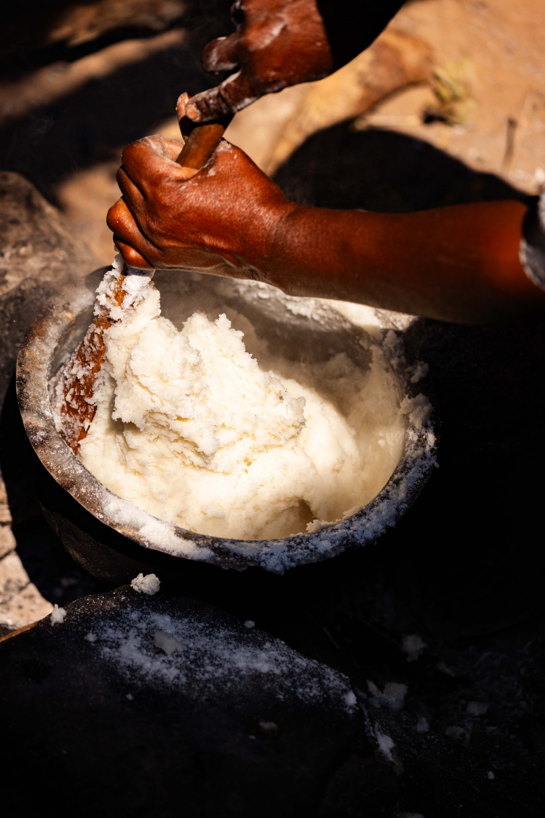 A woman stirring a pot of ugali, made with fortified flour, for her family in Vikindu village, Tanzania. In this region, poorer communities that are most affected by malnutrition tend to source their staple food, maize flour, from village mills.