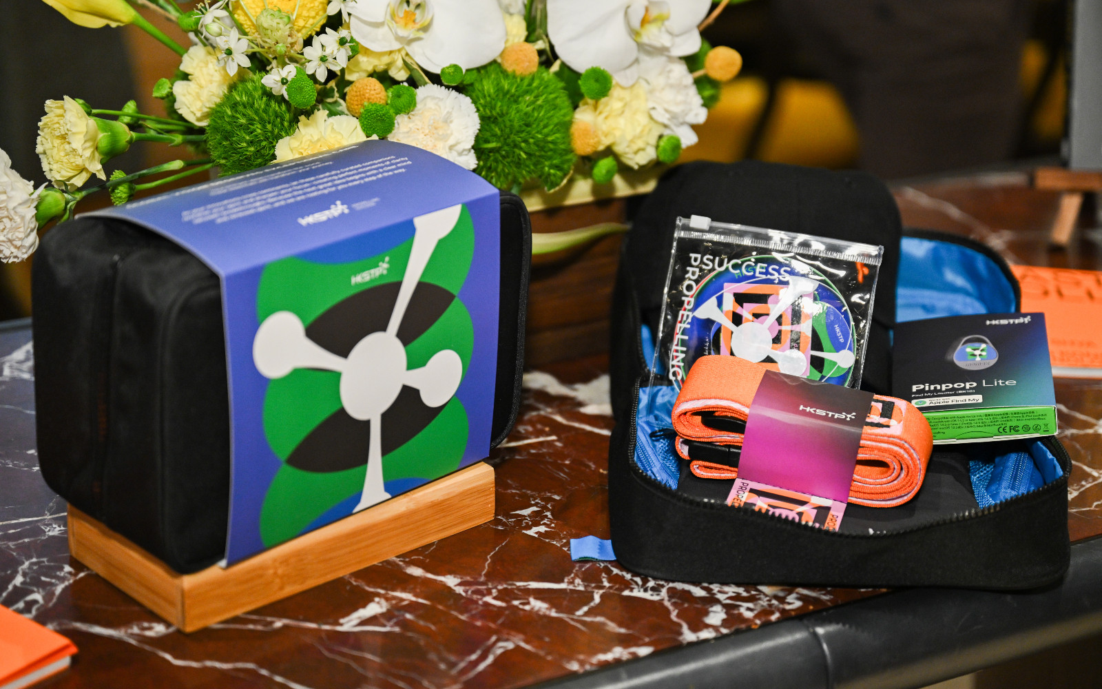 Travel pouches from HKSTP’s ‘Go Global’ series, which include handy tools like suitcase wrap and location tracker Pinpop Lite (Photo: Tatler Hong Kong)