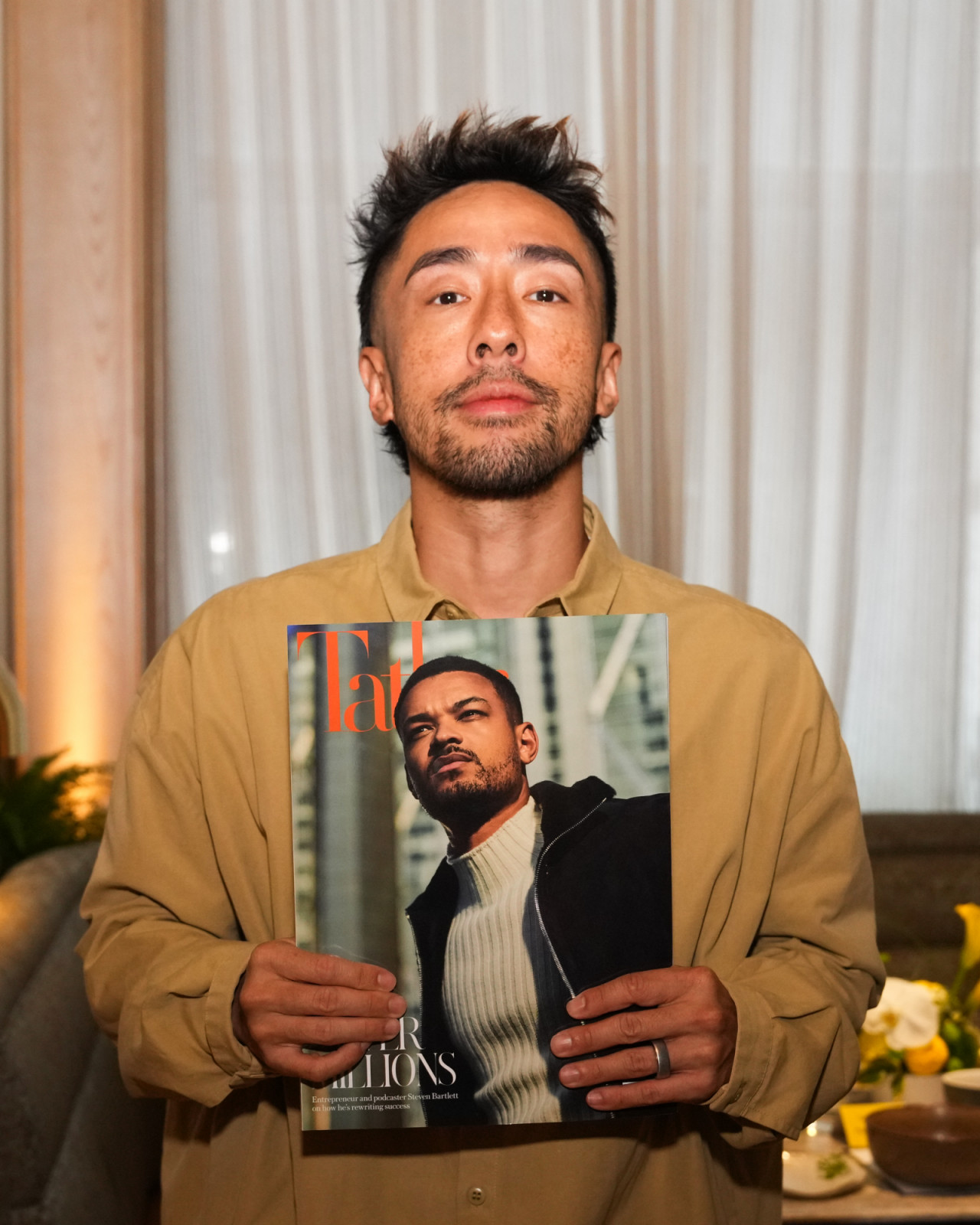 Serial entrepreneur Kevin Poon holds the August issue of Tatler magazine featuring Bartlett as the cover star (Photo: Tatler Hong Kong)