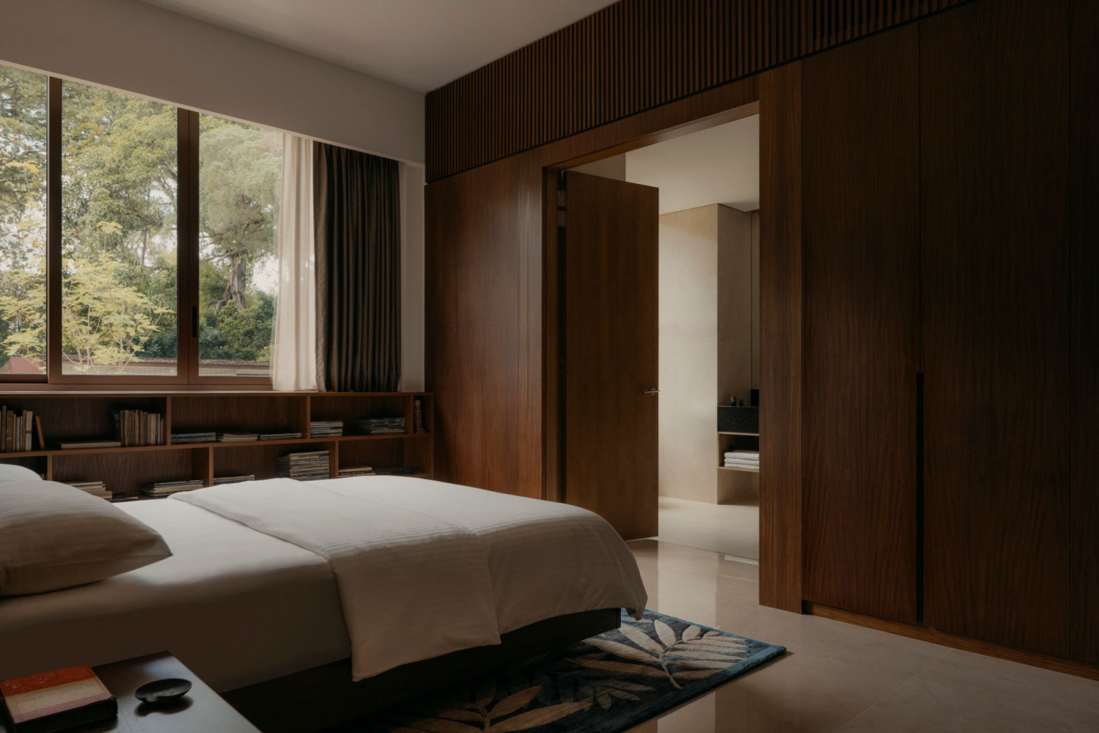 Dark wood lends a hushed, restful ambience to this bedroom