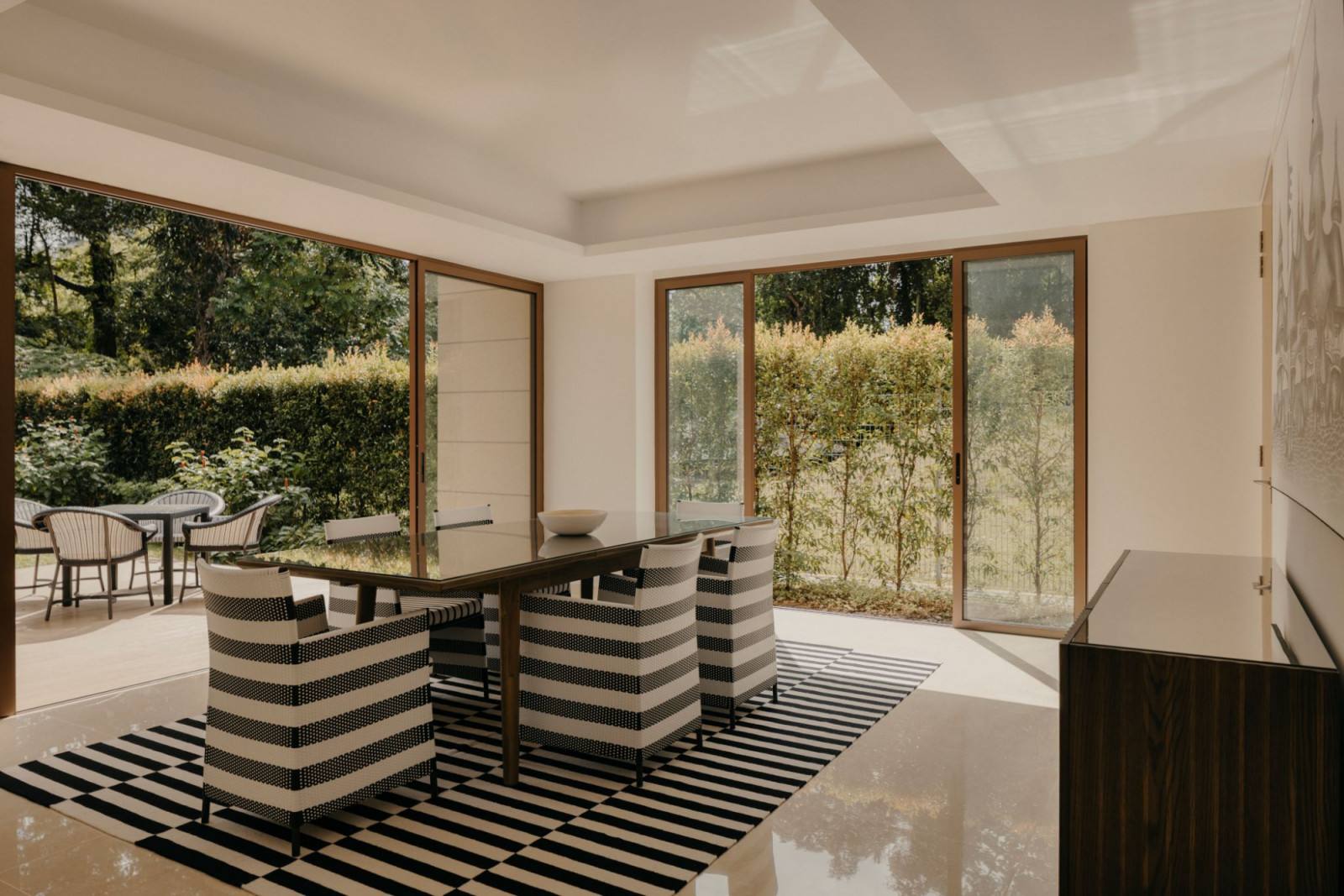 The striped rug and furniture add a graphic touch to an otherwise minimalist room