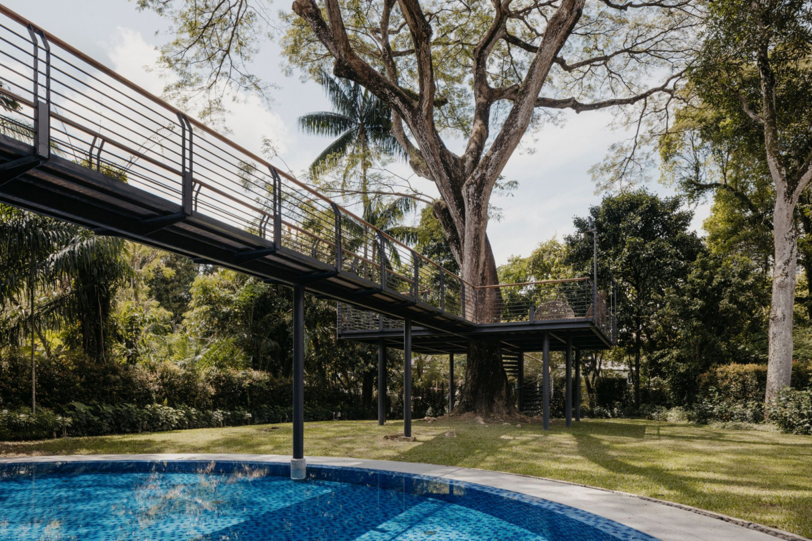 Owner and the project’s architectural designer, Ho Kwon Cjan, often entertains at the outdoor patio, under the shade of the rain tree