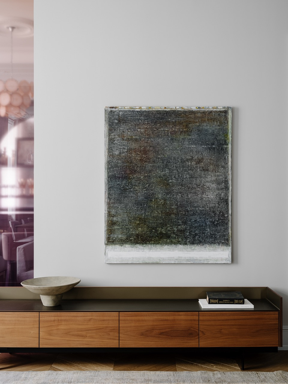 Abstract artwork displayed above custom TV cabinet by Punt in the living room