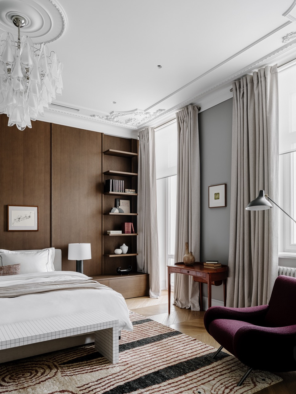 The master bedroom features custom wall panels with shelving, vintage Murano chandelier, and two windows overlooking Moscow